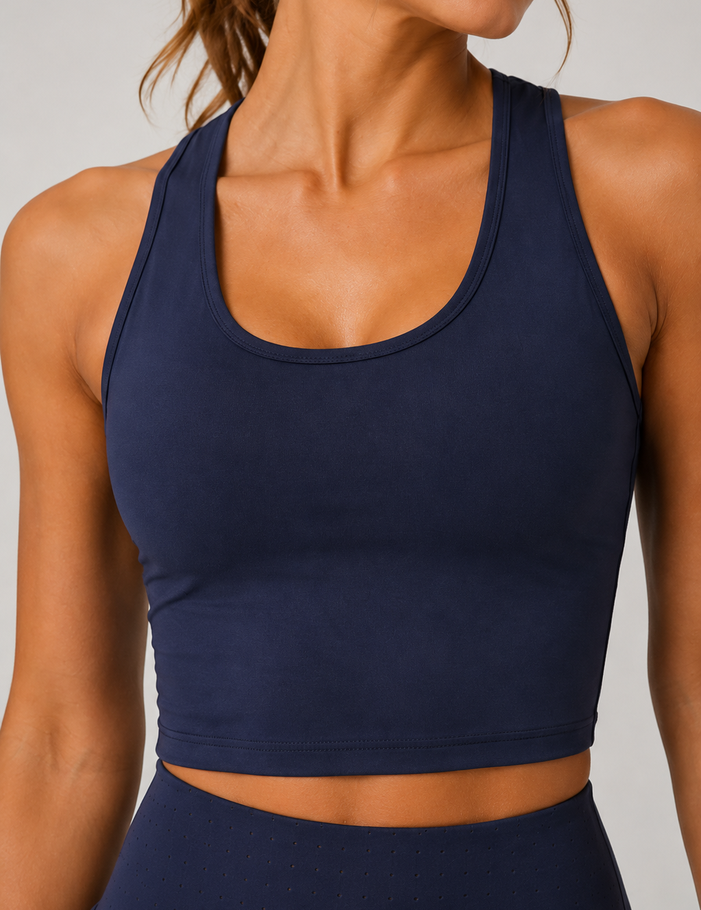 Navy blue sports bra worn by a person on a neutral background