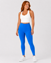 Model wearing Sculp crop top, front view, from Style Luxe Activewear in white and electric wave leggings in blue