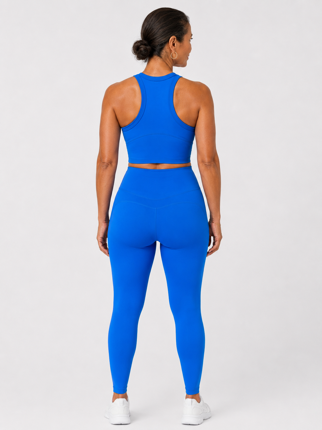 Back view of style luxe electricave high-waist blue leggings on model