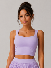 Woman wearing a purple athletic outfit against a plain background