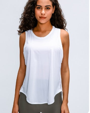 Woman wearing a white sleeveless top with a plain background
