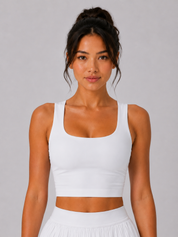 Woman wearing a white tank top against a gray background